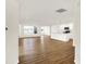 Hardwood floors throughout the open living space leading into the kitchen with modern countertops and white cabinets at 19599 Atwater Ave, Sheridan, IN 46069
