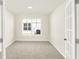 A brightly lit room with neutral walls, carpet and a view of the backyard through a window at 19599 Atwater Ave, Sheridan, IN 46069
