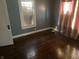 Bedroom featuring hardwood flooring and natural light through the window at 2022 N Olney St, Indianapolis, IN 46218