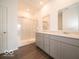Modern bathroom featuring double sinks, light gray cabinets, and marble walk-in shower at 2254 Oakmont Dr, Plainfield, IN 46168