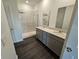 Bathroom with a double sink vanity, walk-in shower with glass door, with modern fixtures and lighting at 2254 Oakmont Dr, Plainfield, IN 46168
