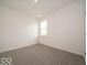A clean bedroom with neutral carpet flooring and a single casement window at 2254 Oakmont Dr, Plainfield, IN 46168