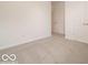 Bedroom showing neutral carpet, white trim, and access to the hallway through an open door at 2254 Oakmont Dr, Plainfield, IN 46168