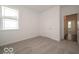 A bright bedroom with neutral carpet flooring and a view to the hallway at 2254 Oakmont Dr, Plainfield, IN 46168