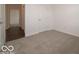 A serene bedroom with neutral carpet flooring and a view to the hallway at 2254 Oakmont Dr, Plainfield, IN 46168