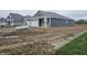 Single-story home featuring a two-car garage and a side entrance, set in a construction phase lot at 2254 Oakmont Dr, Plainfield, IN 46168