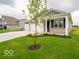 Charming single-story home showcasing a three-car garage, a covered porch, and a well-manicured lawn at 2254 Oakmont Dr, Plainfield, IN 46168