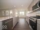 Spacious kitchen boasts stainless steel appliances, light gray cabinets, and a center island with sink and dishwasher at 2254 Oakmont Dr, Plainfield, IN 46168