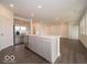 Bright kitchen with island featuring stainless steel dishwasher, sink, and light gray cabinets at 2254 Oakmont Dr, Plainfield, IN 46168