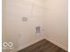 Functional laundry room featuring wood-look flooring and a wire rack for storage at 2254 Oakmont Dr, Plainfield, IN 46168