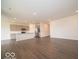 Spacious living space with adjacent kitchen featuring an island and stainless steel appliances at 2254 Oakmont Dr, Plainfield, IN 46168