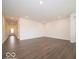 Open-concept living space showcasing wood-look flooring, white walls and recessed lighting at 2254 Oakmont Dr, Plainfield, IN 46168