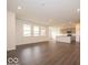 Open-concept living space showcasing wood-look flooring, white walls, and natural light at 2254 Oakmont Dr, Plainfield, IN 46168