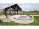 Community pavilion area with picnic tables and firepit for outdoor enjoyment at 2254 Oakmont Dr, Plainfield, IN 46168