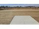 Open backyard with a concrete pad, and temporary fencing on the horizon at 2260 Oakmont Dr, Plainfield, IN 46168