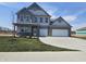 Attractive two-story home boasting a 2-car garage, modern design, and a well-manicured lawn at 2260 Oakmont Dr, Plainfield, IN 46168