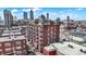 Brick building with views of the Indianapolis skyline and rooftop access. The building features a parking lot at 230 E 9Th St # Apt 405, Indianapolis, IN 46204