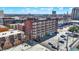 Brick building exterior with white window trim in an urban area. The building has a parking lot and flat roof at 230 E 9Th St # Apt 405, Indianapolis, IN 46204