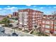 Exterior full view of the red brick apartment building with white windows on a bright day at 230 E 9Th St # Apt 405, Indianapolis, IN 46204