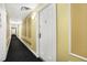 Apartment hallway with neutral decor, lighting, and patterned carpet at 230 E 9Th St # Apt 405, Indianapolis, IN 46204