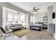 Bright living space with a comfortable sofa, bay window, ceiling fan, and yellow area rug at 230 E 9Th St # Apt 405, Indianapolis, IN 46204