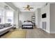 Inviting living space with a comfortable sofa, bay window, ceiling fan, and wall-mounted television at 230 E 9Th St # Apt 405, Indianapolis, IN 46204