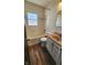 Updated bathroom features modern fixtures, tub, and wood floors at 2317 Courtney Rd, Indianapolis, IN 46219
