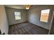 A well-lit bedroom has a ceiling fan, neutral carpeting, and a pair of windows for natural light at 2317 Courtney Rd, Indianapolis, IN 46219