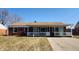 Charming brick home with a covered porch and well-manicured lawn, creating curb appeal at 2317 Courtney Rd, Indianapolis, IN 46219