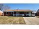 Charming brick home with a covered porch and well-manicured lawn, creating curb appeal at 2317 Courtney Rd, Indianapolis, IN 46219