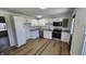 A kitchen with new white cabinets, stainless steel appliances, and granite countertops at 2317 Courtney Rd, Indianapolis, IN 46219