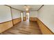 Spacious living room features wood floors, wainscoting, and neutral paint at 2317 Courtney Rd, Indianapolis, IN 46219
