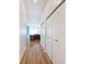 Hallway leading into kitchen with wood flooring and closet space at 233 E St Joseph St # 3H, Indianapolis, IN 46202