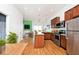 Open kitchen with wooden cabinetry, stainless steel appliances, and natural light at 233 E St Joseph St # 3H, Indianapolis, IN 46202