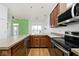 Galley style kitchen with wood cabinets and stone countertops at 233 E St Joseph St # 3H, Indianapolis, IN 46202