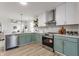 Bright kitchen featuring stainless steel appliances, light green cabinets, and open design at 2361 Salem Park Ct, Indianapolis, IN 46239