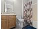Cozy bathroom featuring a wooden vanity and floral shower curtain at 294 Bent Stream Ln, Brownsburg, IN 46112