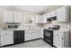 A functional kitchen featuring white cabinets and black appliances at 294 Bent Stream Ln, Brownsburg, IN 46112