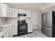 Well-lit kitchen featuring white cabinets and stainless steel refrigerator at 294 Bent Stream Ln, Brownsburg, IN 46112