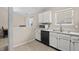 Functional kitchen with white cabinets, black appliances, and a dual sink at 294 Bent Stream Ln, Brownsburg, IN 46112