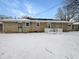 Backyard with snow covered yard and exterior view of the house at 3025 E 6Th St, Anderson, IN 46012