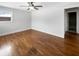 Bright bedroom featuring beautiful hardwood floors, a ceiling fan, and fresh, neutral paint at 3025 E 6Th St, Anderson, IN 46012