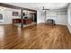 Open-concept living room with hardwood floors, a brick fireplace, and seamless flow into the modern kitchen at 3025 E 6Th St, Anderson, IN 46012