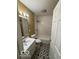 Bright bathroom features tiled walls, stylish flooring, and modern fixtures and shower-tub combo at 3302 E 42Nd St, Indianapolis, IN 46205