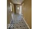 Welcoming hallway featuring unique geometric tiled flooring, a front door, and neutral paint at 3302 E 42Nd St, Indianapolis, IN 46205
