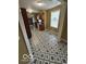 Spacious kitchen featuring geometric-patterned floors, brown cabinets, and modern appliances at 3302 E 42Nd St, Indianapolis, IN 46205
