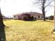 Wide backyard view showcases a vast, well-kept lawn, shade trees and a pergola deck, offering a private and relaxing space at 3534 Country Walk Dr, Indianapolis, IN 46227