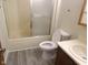 Clean bathroom with a shower-tub combo, modern toilet, updated vanity, and new vinyl flooring at 3534 Country Walk Dr, Indianapolis, IN 46227