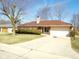 Brick home with manicured lawn, attached garage, and basketball hoop on a sunny day at 3534 Country Walk Dr, Indianapolis, IN 46227