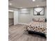Cozy bedroom features wood floors, a window, and a decorative floral quilt at 3561 Bowen Pl, Indianapolis, IN 46221